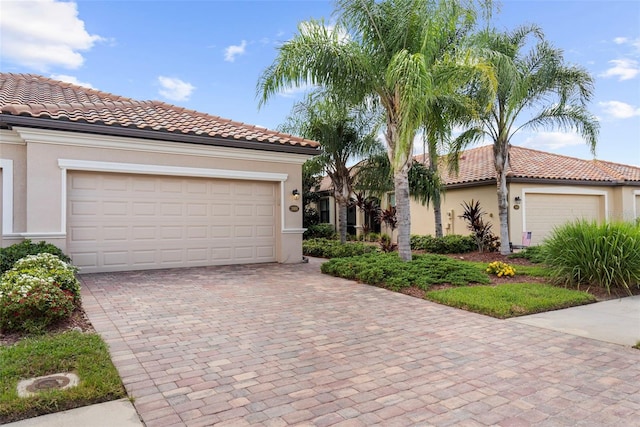 mediterranean / spanish-style house with a garage