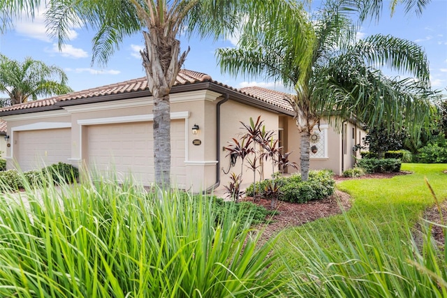 view of front of home featuring a garage and a front lawn