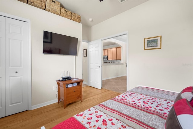 bedroom featuring hardwood / wood-style floors and a closet