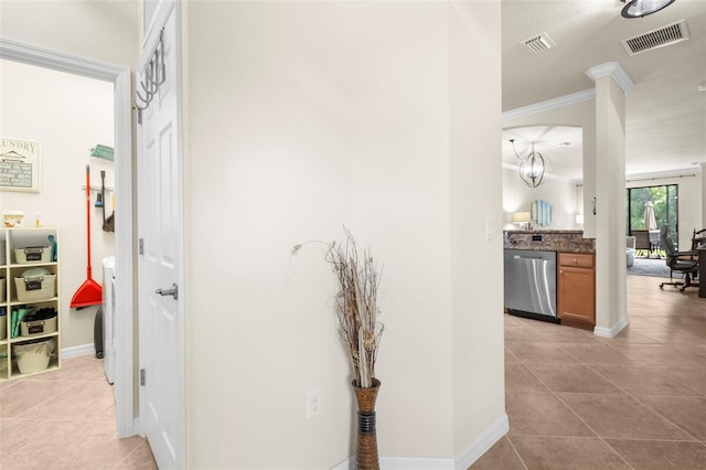 hallway featuring ornamental molding and light tile patterned flooring