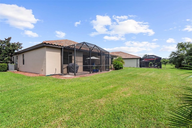 view of yard with a lanai and central AC