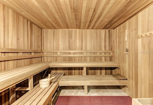 view of sauna / steam room with wood ceiling and wooden walls