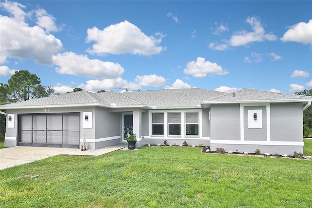 view of front of house with a front yard and a garage