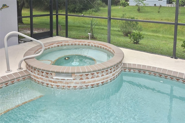 view of swimming pool with an in ground hot tub