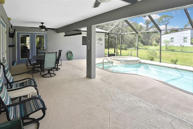 view of swimming pool featuring ceiling fan, a lanai, an in ground hot tub, and a patio