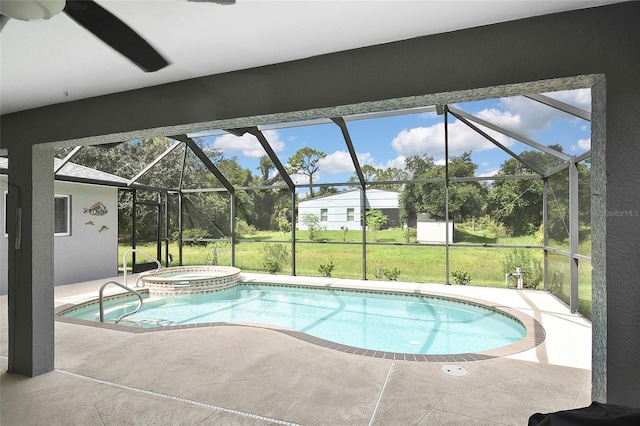 view of swimming pool featuring ceiling fan, a patio area, an in ground hot tub, and glass enclosure