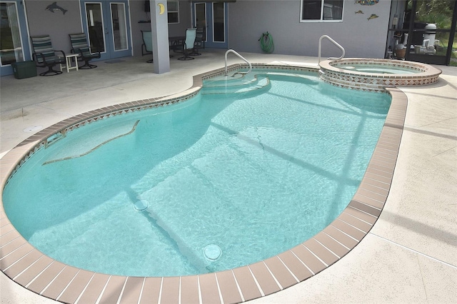 view of pool with an in ground hot tub, french doors, and a patio area