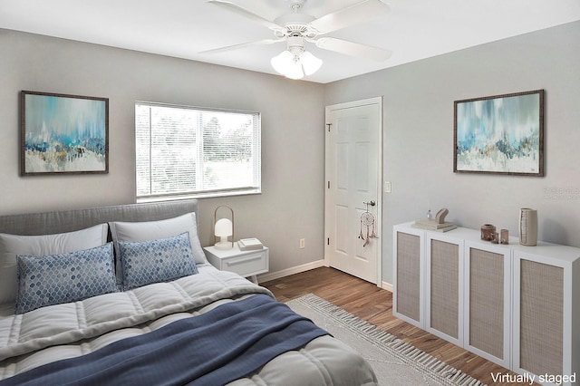 bedroom featuring ceiling fan and dark wood-type flooring