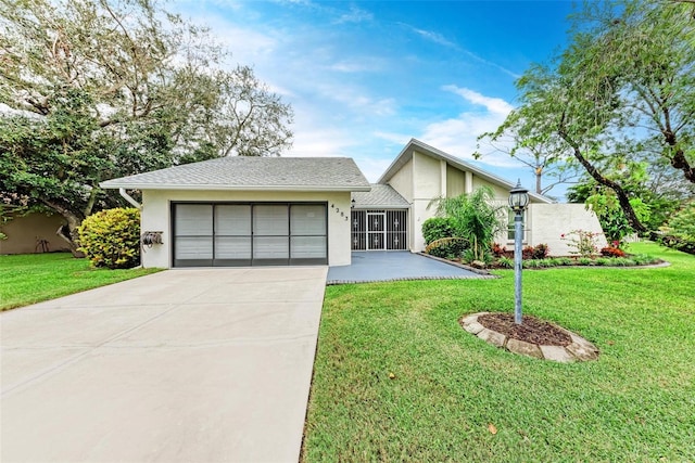 view of front facade with a front yard and a garage