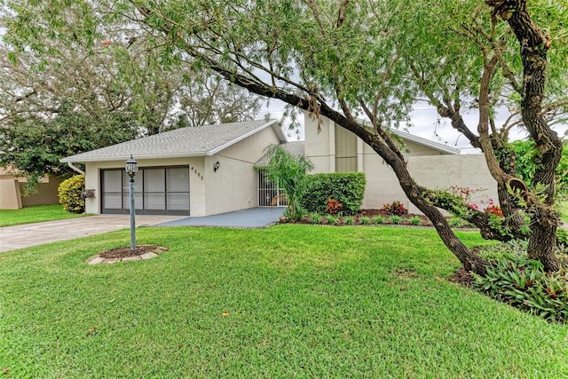 ranch-style house with a garage and a front yard