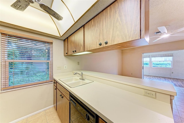 kitchen featuring ceiling fan, black dishwasher, kitchen peninsula, and sink