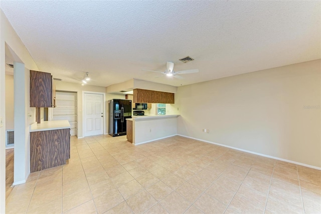 kitchen with kitchen peninsula, light tile patterned flooring, ceiling fan, and black appliances