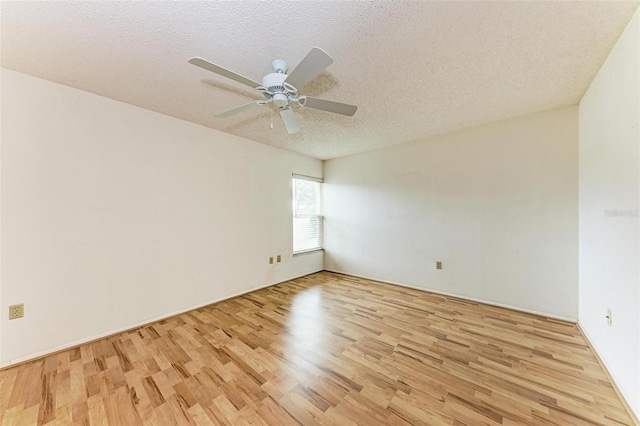 spare room featuring a textured ceiling, light hardwood / wood-style flooring, and ceiling fan