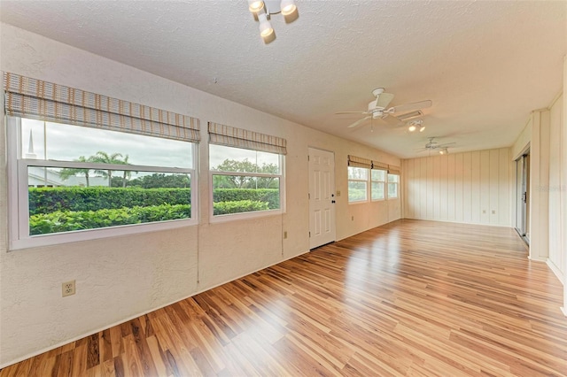 spare room featuring ceiling fan, a textured ceiling, and light wood-type flooring