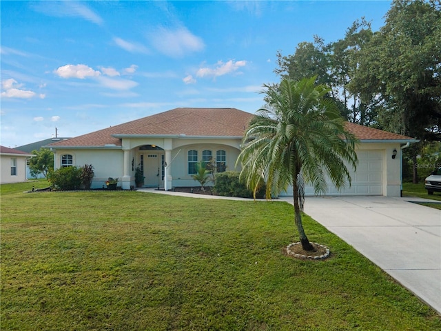 mediterranean / spanish house with a front lawn and a garage