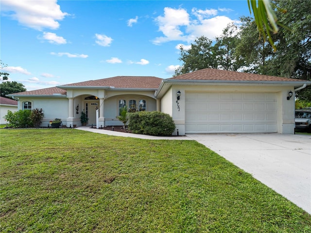 view of front of house with a garage and a front lawn