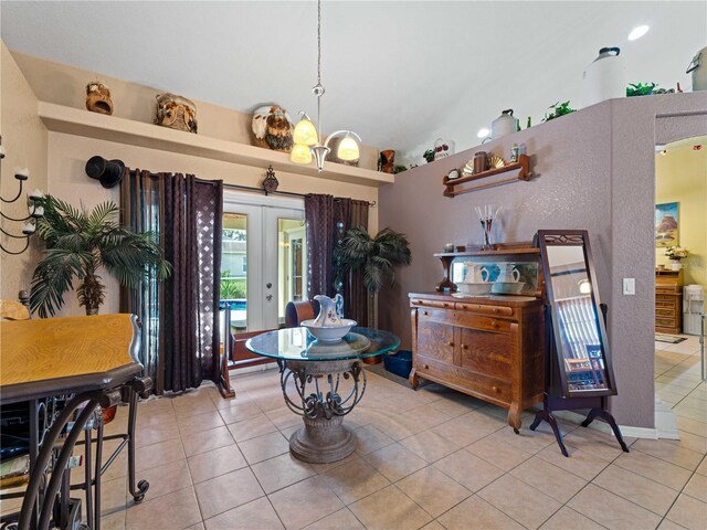 tiled dining room with french doors and lofted ceiling