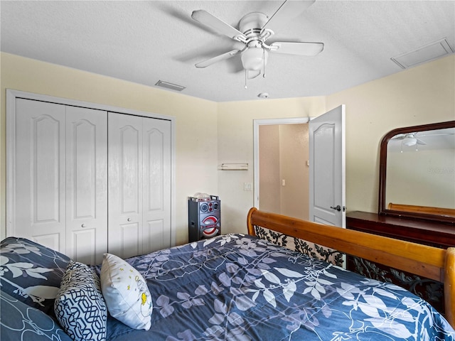 bedroom with a closet, ceiling fan, and a textured ceiling