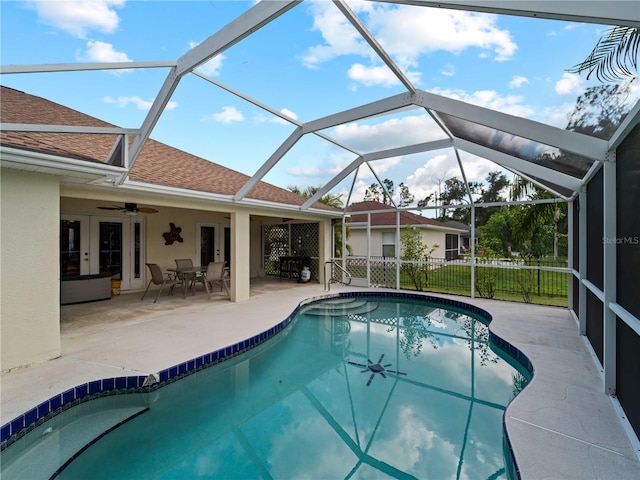 view of pool with ceiling fan, a patio, and a lanai