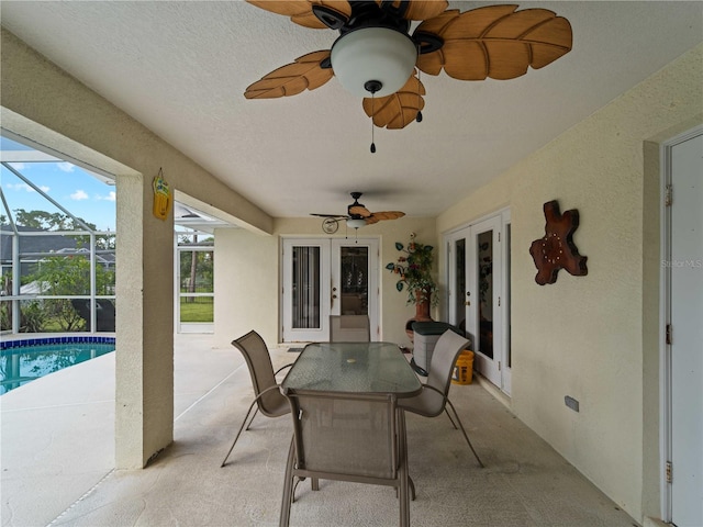 exterior space featuring french doors, glass enclosure, and ceiling fan