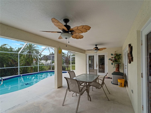 view of swimming pool featuring a lanai, ceiling fan, and a patio area