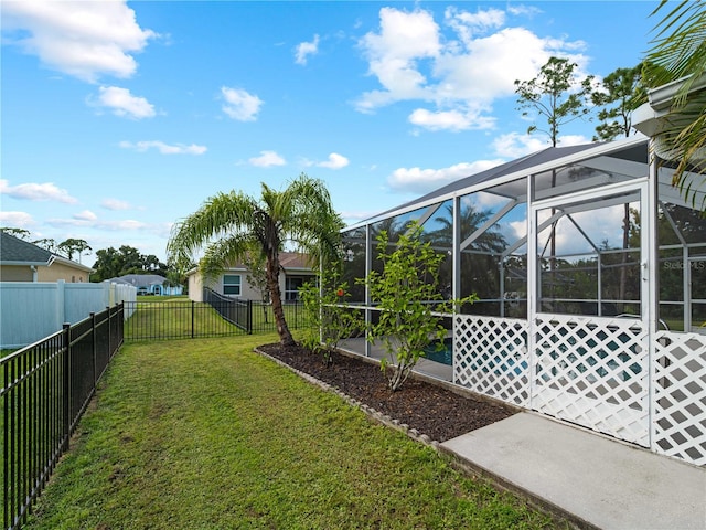 view of yard with glass enclosure