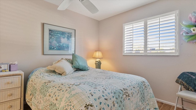 bedroom with wood-type flooring and ceiling fan