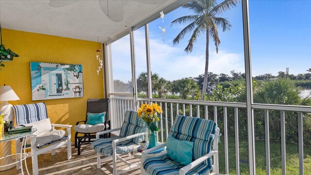 sunroom / solarium featuring ceiling fan