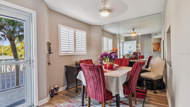 dining area with wood-type flooring and ceiling fan