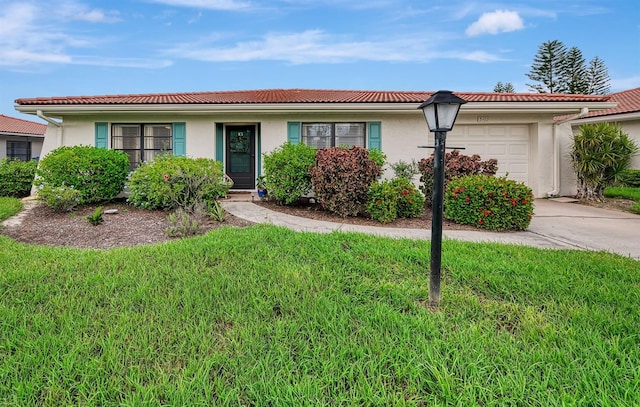 ranch-style home with a garage and a front lawn