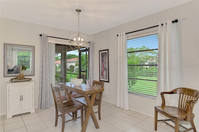 dining room with plenty of natural light, a chandelier, and light tile patterned flooring