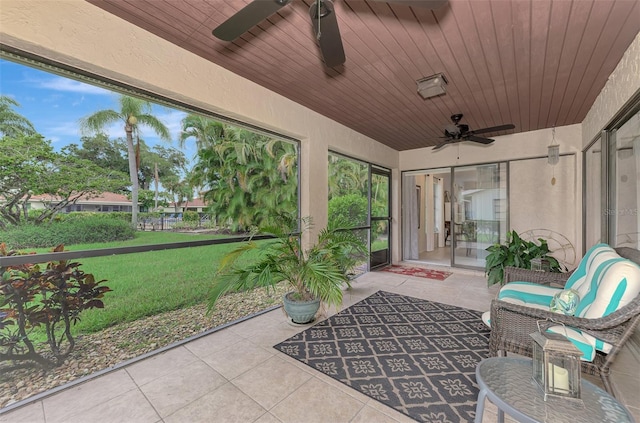 unfurnished sunroom with wood ceiling and ceiling fan