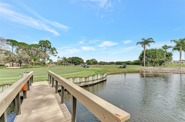 dock area with a yard and a water view