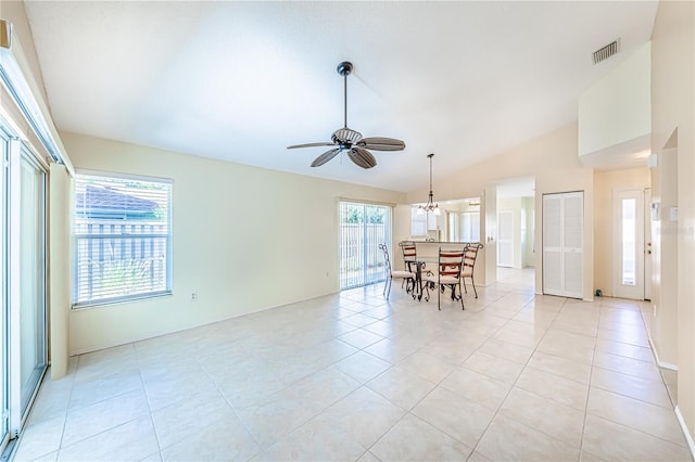 unfurnished room with lofted ceiling, light tile patterned flooring, and ceiling fan