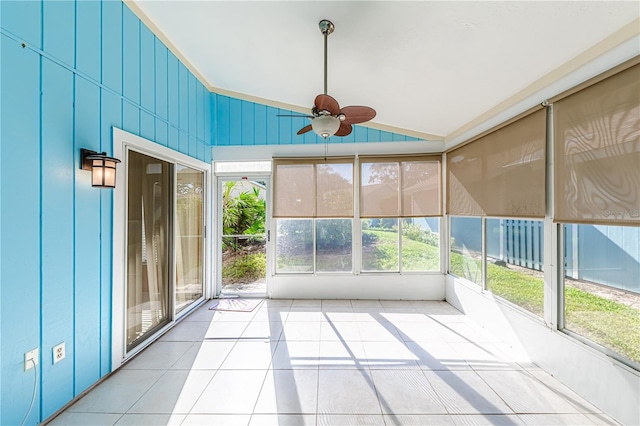 unfurnished sunroom with a wealth of natural light, ceiling fan, and vaulted ceiling