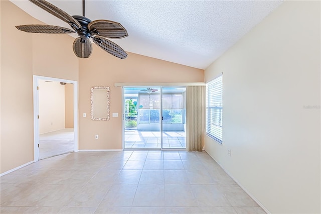 tiled empty room featuring high vaulted ceiling, ceiling fan, and a textured ceiling