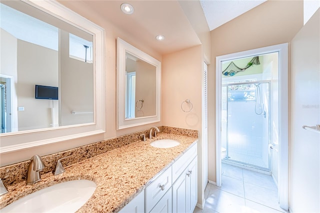 bathroom featuring tile patterned flooring, vanity, toilet, and a shower