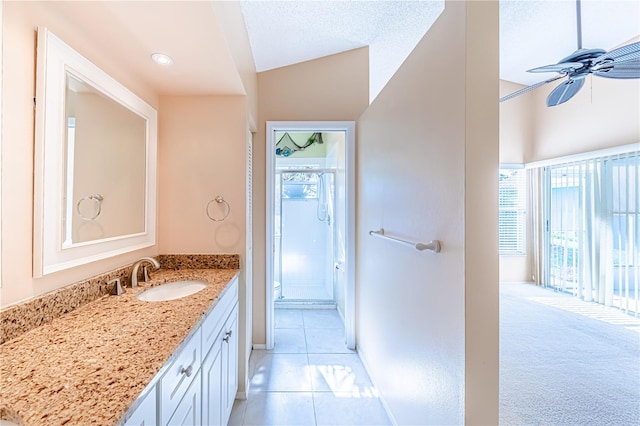 bathroom featuring vanity, vaulted ceiling, a shower with shower door, tile patterned floors, and ceiling fan