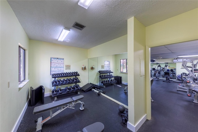 exercise room featuring a textured ceiling