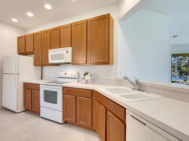 kitchen featuring sink, white appliances, and light tile patterned floors