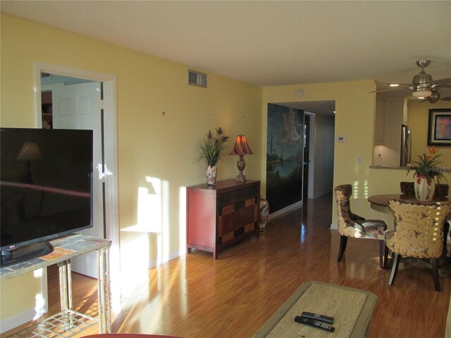 living room featuring ceiling fan and wood-type flooring