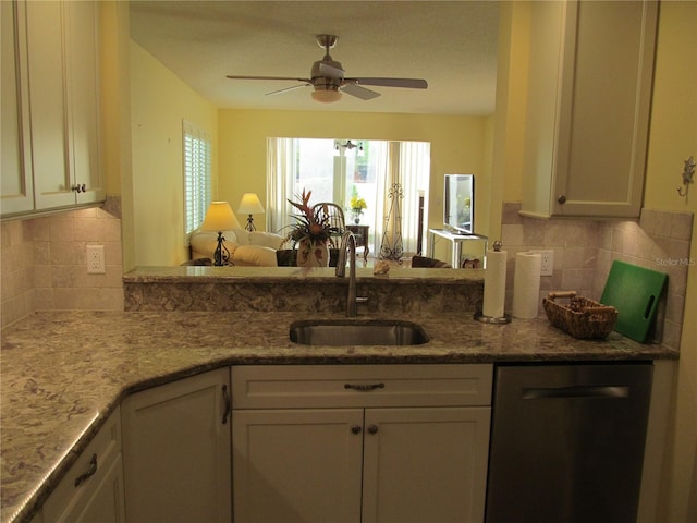 kitchen featuring backsplash, ceiling fan, sink, and stainless steel dishwasher