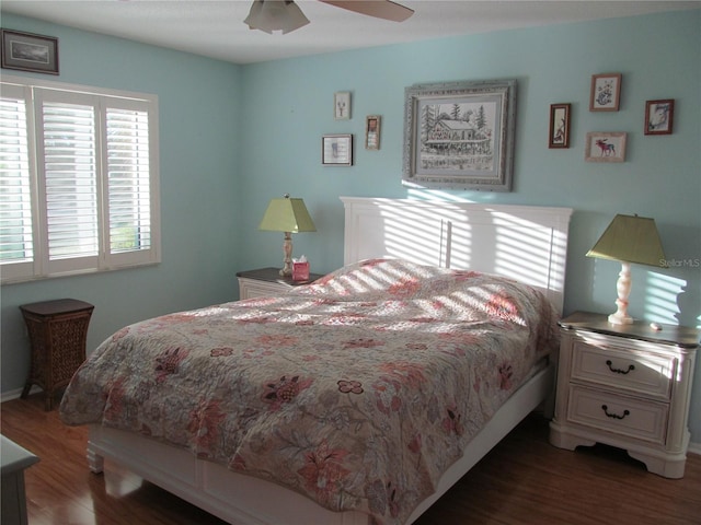 bedroom with dark hardwood / wood-style floors and ceiling fan