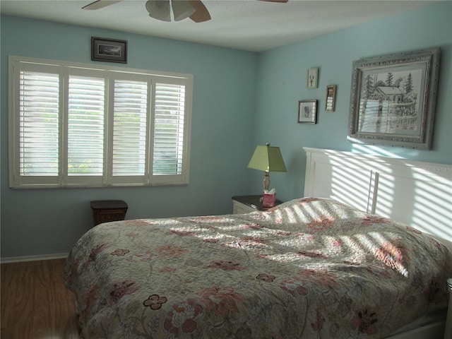 bedroom with hardwood / wood-style flooring and ceiling fan