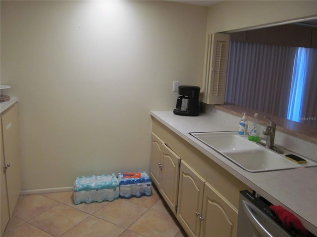 kitchen with dishwasher, light tile patterned floors, and sink