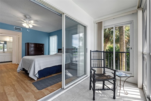 bedroom with ceiling fan, access to outside, light hardwood / wood-style floors, and multiple windows