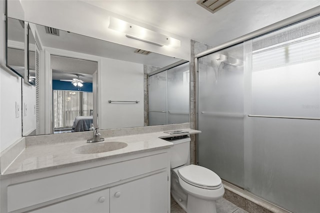 bathroom with an enclosed shower, tile patterned floors, ceiling fan, vanity, and toilet