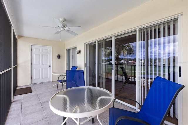 sunroom featuring ceiling fan