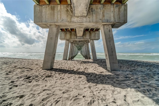 exterior space with a water view and a beach view