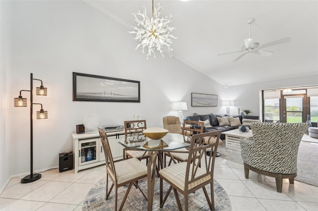 dining room featuring ceiling fan with notable chandelier, light tile patterned floors, crown molding, and high vaulted ceiling